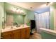 Bathroom featuring double sink vanity with a combination tub and shower at 1122 Birkdale Dr, Mebane, NC 27302