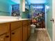 Well-lit bathroom featuring tiled floors, shower with a Ninja Turtles themed shower curtain at 1122 Birkdale Dr, Mebane, NC 27302