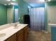 Bathroom with double sink vanity, tile floors and shower with tub at 1122 Birkdale Dr, Mebane, NC 27302
