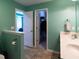 Bathroom with double sink vanity, toilet, and doorways to bedroom and closet at 1122 Birkdale Dr, Mebane, NC 27302