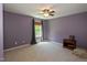Spacious carpeted bedroom featuring a ceiling fan, natural light, and stylish paint at 1122 Birkdale Dr, Mebane, NC 27302