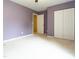 The bedroom is brightly lit with a lovely lavender color and a double closet at 1122 Birkdale Dr, Mebane, NC 27302