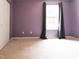 Bedroom with purple walls, neutral carpet and a bright window with curtains at 1122 Birkdale Dr, Mebane, NC 27302