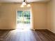 Bright dining area featuring sliding glass doors leading to outside, hardwood floors, and modern lighting at 1122 Birkdale Dr, Mebane, NC 27302