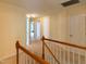 Upstairs hallway with carpeted floors and doors leading to the bedrooms at 1122 Birkdale Dr, Mebane, NC 27302