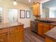 Updated kitchen features wood cabinets, stainless steel dishwasher, and laminate countertops at 1122 Birkdale Dr, Mebane, NC 27302