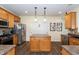 Well-organized kitchen featuring an island, stainless steel fridge, light cabinets, and modern fixtures at 1122 Birkdale Dr, Mebane, NC 27302