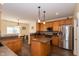Spacious kitchen with warm wood cabinets, an island, modern stainless steel appliances and durable flooring at 1122 Birkdale Dr, Mebane, NC 27302