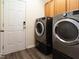 Laundry room with modern washer and dryer next to the exterior door at 1122 Birkdale Dr, Mebane, NC 27302