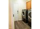 Laundry room featuring modern washer and dryer set with overhead cabinet storage at 1122 Birkdale Dr, Mebane, NC 27302