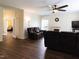 Open living room with hardwood floors, ceiling fan, fireplace, and plenty of room to relax and unwind at 1122 Birkdale Dr, Mebane, NC 27302