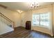 Inviting living room features a staircase, a front door, a window and nice laminate flooring at 1122 Birkdale Dr, Mebane, NC 27302