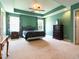 Spacious main bedroom with tray ceiling, ceiling fan, carpet floors, and dual windows at 1122 Birkdale Dr, Mebane, NC 27302