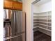 Walk-in pantry features hardwood floors and plenty of shelves at 1122 Birkdale Dr, Mebane, NC 27302