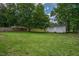 Large backyard with lush green grass and a two-car detached garage at 1203 First Street Ext, Nashville, NC 27856