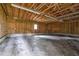 Interior of an empty two-car garage with wood beam ceiling and concrete floor at 1203 First Street Ext, Nashville, NC 27856