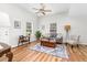 Inviting living room with a ceiling fan, wood-look floors, a cozy rug, and natural light at 1203 First Street Ext, Nashville, NC 27856