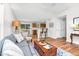 Open-concept living room featuring wood floors, a plush sofa, and seamless flow to the kitchen at 1203 First Street Ext, Nashville, NC 27856