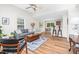 Bright open-concept living room with wood floors, ceiling fan, and access to the dining area at 1203 First Street Ext, Nashville, NC 27856