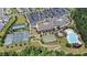 Aerial view showcases the community clubhouse, pool, tennis and bocce courts, and lush landscaping at 1204 E Rosedale Creek Dr, Durham, NC 27703