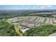 Community aerial view with multiple homes, amenities, clubhouse, landscaping, and ample parking at 1204 E Rosedale Creek Dr, Durham, NC 27703