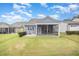Charming backyard with a screened porch and well-maintained lawn at 1204 E Rosedale Creek Dr, Durham, NC 27703
