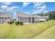Backyard featuring a lawn, screened porch, and view of the neighborhood at 1204 E Rosedale Creek Dr, Durham, NC 27703