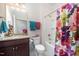 Bathroom showcases a granite countertop vanity, ample lighting and a shower-tub combination at 1204 E Rosedale Creek Dr, Durham, NC 27703