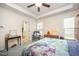 Bright bedroom features a tray ceiling, a ceiling fan, and is filled with natural light at 1204 E Rosedale Creek Dr, Durham, NC 27703
