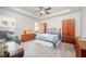 Spacious bedroom with tray ceiling, ceiling fan, and ample natural light from large windows at 1204 E Rosedale Creek Dr, Durham, NC 27703