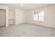 Large bonus room offers flexible space with natural light and a built-in shelving unit at 1204 E Rosedale Creek Dr, Durham, NC 27703