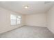 Large bonus room provides versatile space with natural light and plush carpeting at 1204 E Rosedale Creek Dr, Durham, NC 27703