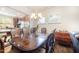 Elegant dining area with a hardwood table, chandelier, and view to the kitchen at 1204 E Rosedale Creek Dr, Durham, NC 27703
