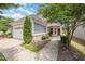 Inviting home front with well-maintained landscaping, a two-car garage, and covered entryway at 1204 E Rosedale Creek Dr, Durham, NC 27703