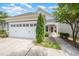 Charming home exterior with a two-car garage, manicured lawn, and inviting covered front porch at 1204 E Rosedale Creek Dr, Durham, NC 27703