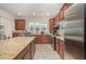 Well-equipped kitchen with granite counters, stainless steel appliances, and dark wood cabinetry at 1204 E Rosedale Creek Dr, Durham, NC 27703