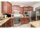 Well-equipped kitchen features stainless steel appliances, granite countertops, and custom cabinetry at 1204 E Rosedale Creek Dr, Durham, NC 27703