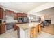 Modern kitchen with stainless steel appliances, granite countertops, and an island with stools at 1204 E Rosedale Creek Dr, Durham, NC 27703