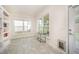 Bright sun room featuring large windows, tiled floors, and built-in shelving, perfect for relaxation at 1204 E Rosedale Creek Dr, Durham, NC 27703