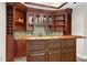 Stylish bar with a wood countertop, mosaic backsplash, glass cabinets, and convenient wine rack at 12257 Beestone Ln, Raleigh, NC 27614