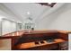 Spacious basement area with a wooden bar, recessed lights, and a view of the living area at 12257 Beestone Ln, Raleigh, NC 27614