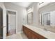 Dual sinks sit beneath stylish mirrors in this Primary bathroom with tile flooring at 12257 Beestone Ln, Raleigh, NC 27614