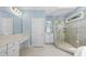 Well-lit bathroom featuring a glass-enclosed shower, vanity, and modern fixtures at 12257 Beestone Ln, Raleigh, NC 27614