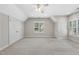 Spacious bedroom with neutral carpet, ceiling fan, and abundant natural light at 12257 Beestone Ln, Raleigh, NC 27614