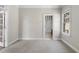 Bright bedroom featuring neutral walls, soft carpet, and doorway leading to an ensuite bath at 12257 Beestone Ln, Raleigh, NC 27614