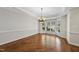 Bright dining room with hardwood floors, decorative chandelier, large bay windows with plantation shutters at 12257 Beestone Ln, Raleigh, NC 27614