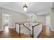 Open foyer showcasing hardwood floors and a wooden staircase with white railings at 12257 Beestone Ln, Raleigh, NC 27614