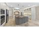 Gourmet kitchen with center island, stainless steel appliances, and custom cabinetry at 12257 Beestone Ln, Raleigh, NC 27614