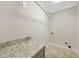 A functional laundry room with granite countertop and a convenient rod for hang-drying clothing at 12257 Beestone Ln, Raleigh, NC 27614