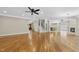 Hardwood flooring in an open living area with a staircase, a fireplace and an eat-in kitchen at 12257 Beestone Ln, Raleigh, NC 27614